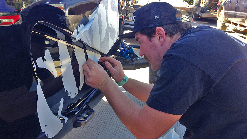 Brad carefully applies COPS branding to the new ES-Motorsports-built Class 1 car.