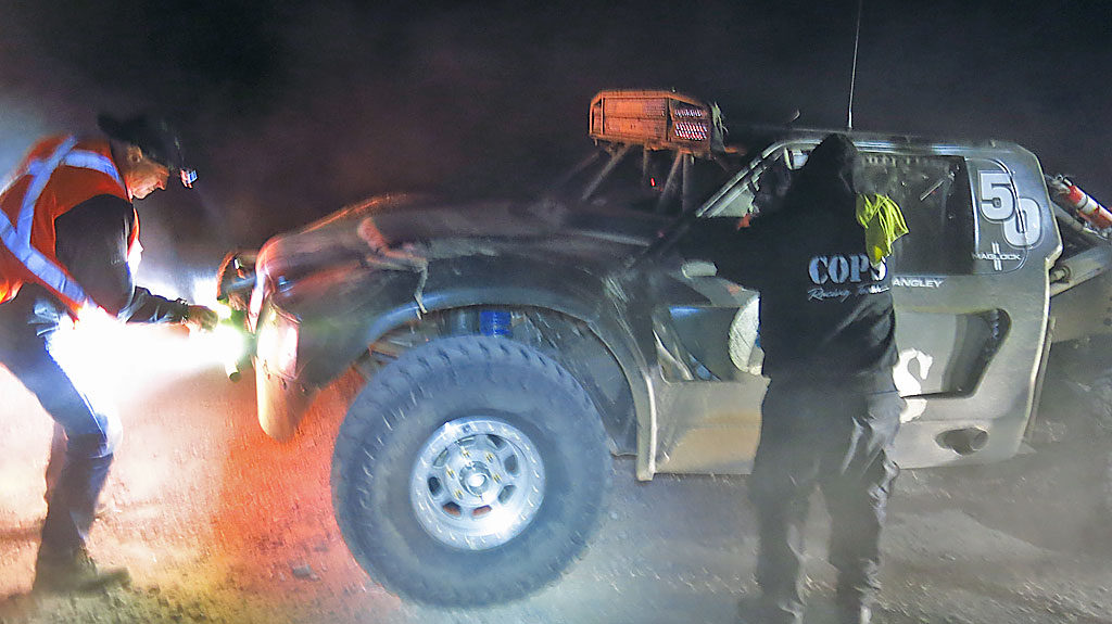 The COPS Trophy Truck and Class 1 stopped to take on fuel at Race Mile 593/710. Dirty driving lights required cleaning, but nothing else was needed during the stop.