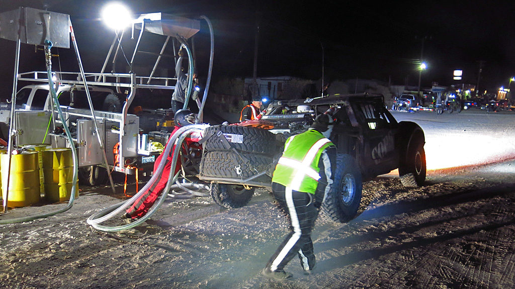 Fueling towers and gravity help keep pit times to a minimum during this 2 a.m. pit stop. Once the car left the pit, it would complete a big loop in the desert and return for fuel in about two hours.