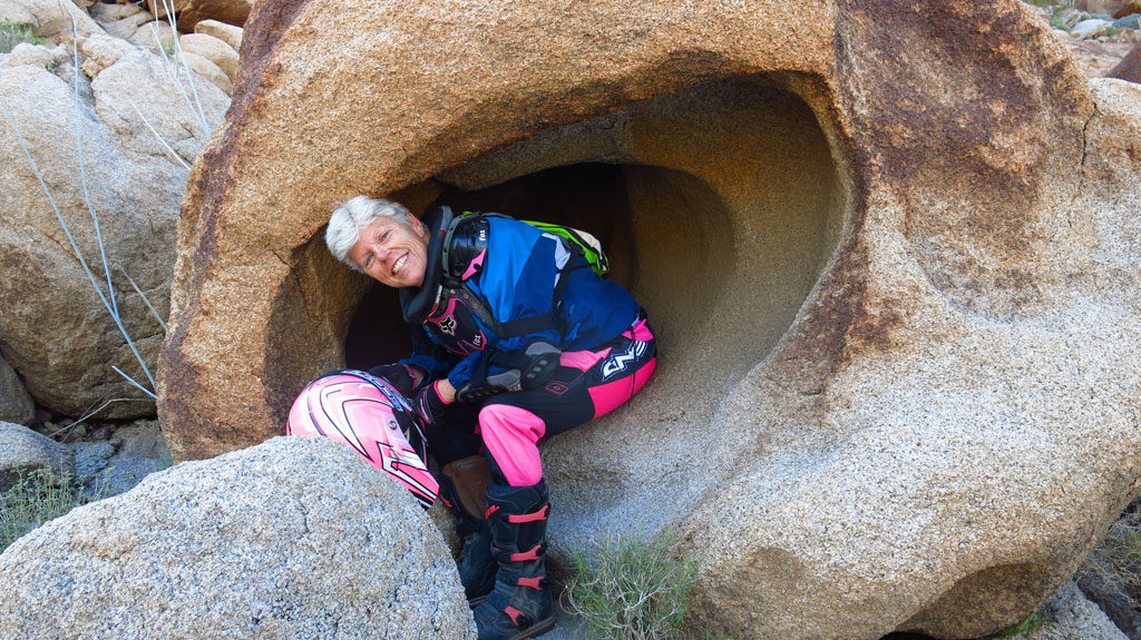 We rest from riding inside a big ear-like rock.