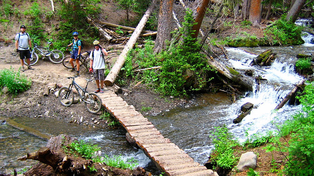 Mark, Carol and John at a creek crossing. John salutes and Mark inhales. Mark, Carol and John at a creek crossing. John salutes and Mark inhales.
