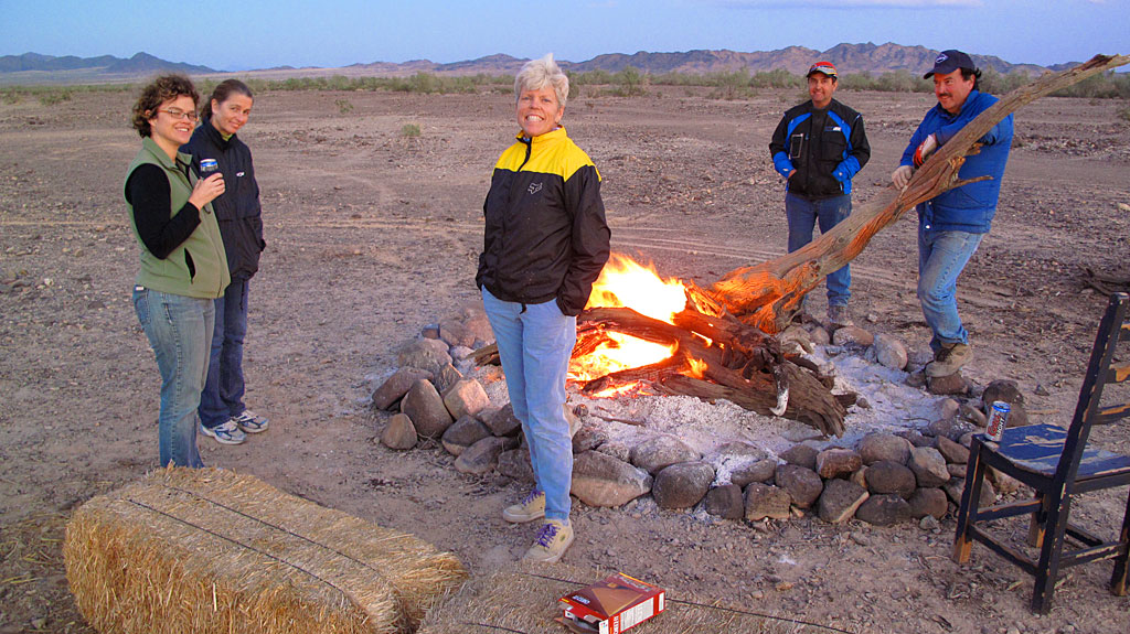 Robert and Henri stoke the fire while Sandy, KT and Carol keep warm. Robert and Henri stoke the fire while Sandy, KT and Carol try to keep warm.