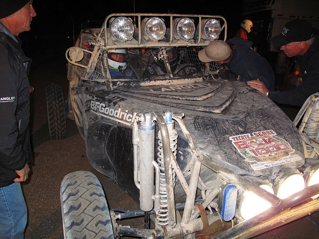 Morgan Langley brought the Class 12 in for the fuel stop. The car started in Ensenada, 15 hours earlier, and with the exception of getting stuck in a silt bed for 30 minutes, the trip was uneventful. Joe Taylor, COPS Crew Chief supervises from the left. Morgan Langley brought the Class 12 in for the fuel stop. The car started in Ensenada, 15 hours earlier, and with the exception of getting stuck in a silt bed for 30 minutes, the trip was uneventful. Joe Taylor, COPS Crew Chief supervises from the left.