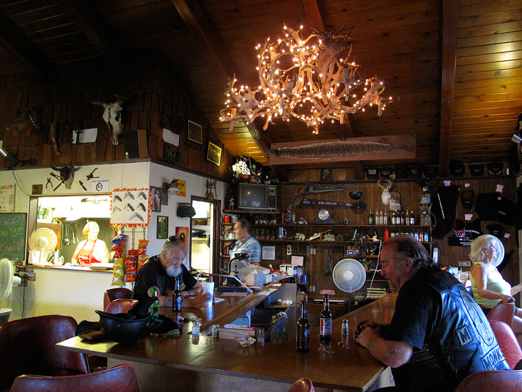 Grumpy Bear's restaurant and bar. The lady in the box cooks the food you order, which, by the way, she can't make because they're out of everything you'd like to order. The lady on the right was watching the rain out the window and thoroughly enjoying the afternoon, if we catch our drift. Grumpy Bear's restaurant and bar. The lady in the box cooks the food you order, which, by the way, she can't make because they're out of everything you'd like to order. The lady on the right was watching the rain out the window and thoroughly enjoying the afternoon, if we catch our drift.