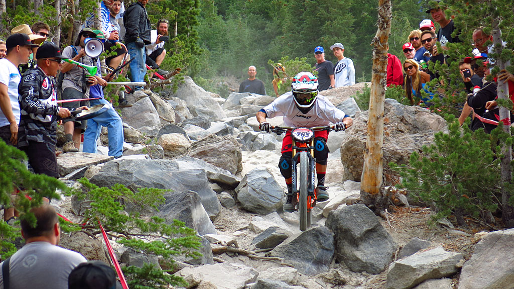 Men's Pro Downhill at a <a title="Google Maps" href="http://goo.gl/maps/L91Lq" target="_blank">nasty rock garden</a> just below the top of Chair 16. As always, the photos don't do justice to the speed or steepness of the trail, or the skill of the rider. The guy with the megaphone on the left was very, very "enthusiastic," if you catch our drift.