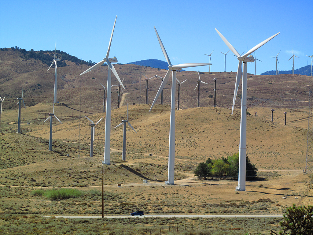 Wind turbines towering over Oak Creek Road, near Mojave, California.