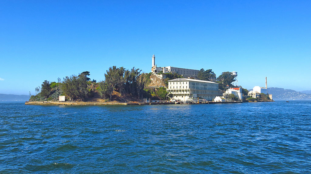Alcatraz is 1.5 miles into the San Francisco Bay first documented by Spanish explorers in 1775 who named the island "La Isla de los Alcatraces" (The Island of the Pelicans). It stands 135 feet out of the water and was a military garrison, then a military prison, then a federal penitentiary, and now part of the National Park System.