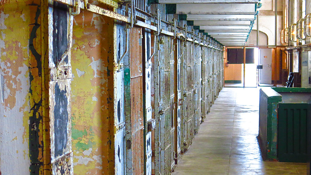 The basement of Alcatraz contained some showers and a dungeon (solitary confinement) accessed from A-Block. The green stairway to the basement is on the ride side of the photo