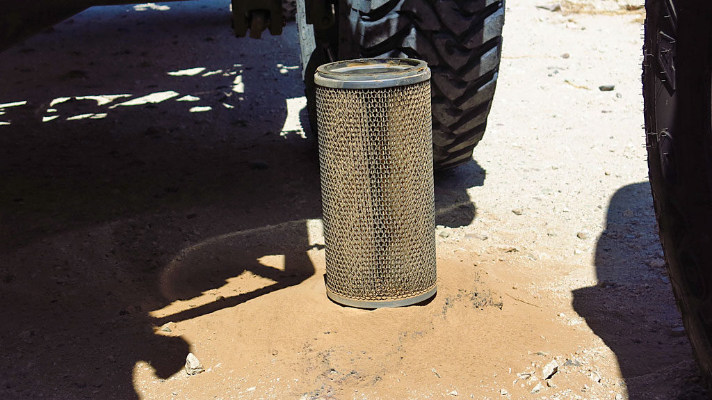 Dennis swapped out the #250's air filter - he dropped the old filter on the ground and a little light brown silt came out.
