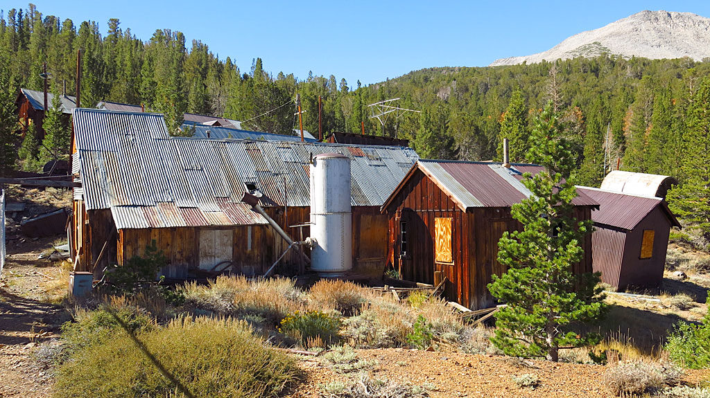 The hoist house and assay shack are adjacent to the headframe, with most of their equipment intact.