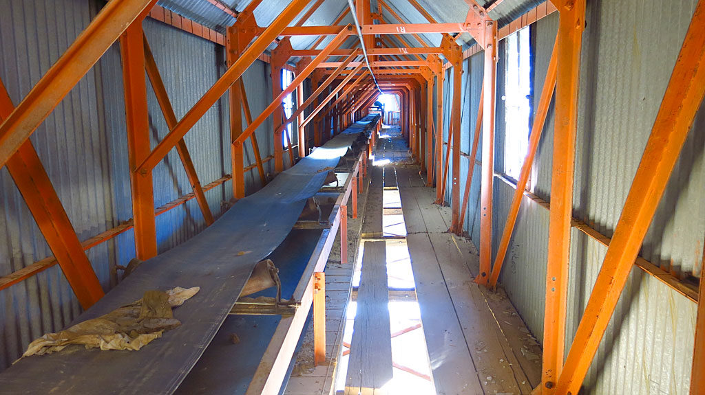 Looking up, inside the covered conveyor belt.