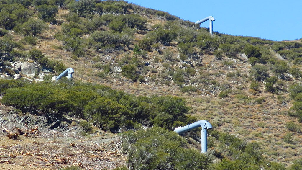 Caltrans: "... permanent propane and oxygen gas explosion chambers (<a href="http://www.mountec-corp.com/en/avalanche/gazex" target="_blank">GazEx</a>) at the head of avalanche chutes, approximately 3/4 mile upslope from U.S. Highway 395. The GazEx system consists of exploders mounted in the avalanche starting zones above the highway. The exploders are large tubes, closed at one end, open at the other, with their open ends located above and directed onto the snow. The exploders are filled by remote control with propane and oxygen, then remotely detonated. The shelters contain the remote control system and the oxygen and propane tanks for the system. The operator controls the system from a safe location using a computer linked by radio to the control systems in the shelters. The propane and oxygen tanks would be removed in the spring and replaced in late fall/early winter (October 15-November 1). This would avoid having propane and oxygen gas tanks on the mountain during fire season."