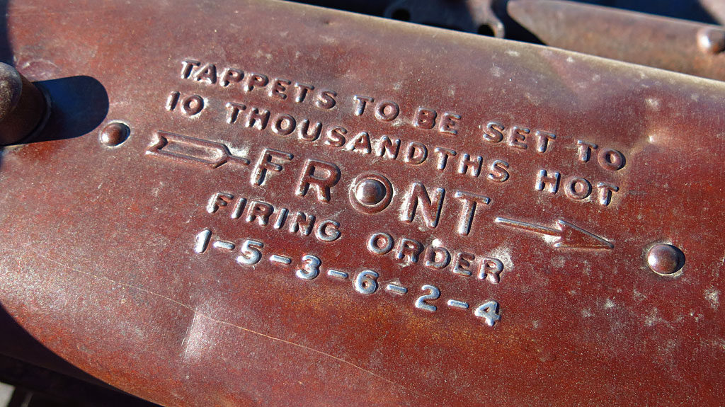 Maintenance instructions on an old Ford's valve cover.