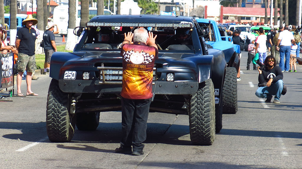 NORRA President Mike Pearlman signals John that he has 10 seconds until his start. It was Mike's dad, Ed, who started this race 50 years ago at the same spot.