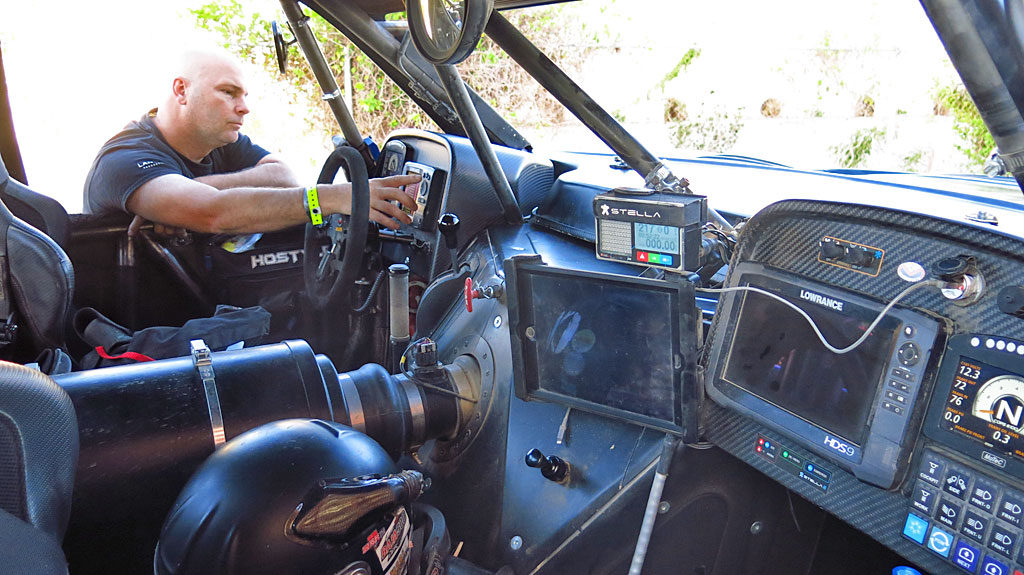 Inside the #250's cockpit, Co-driver Mike makes last-minute adjustments to John's GPS.