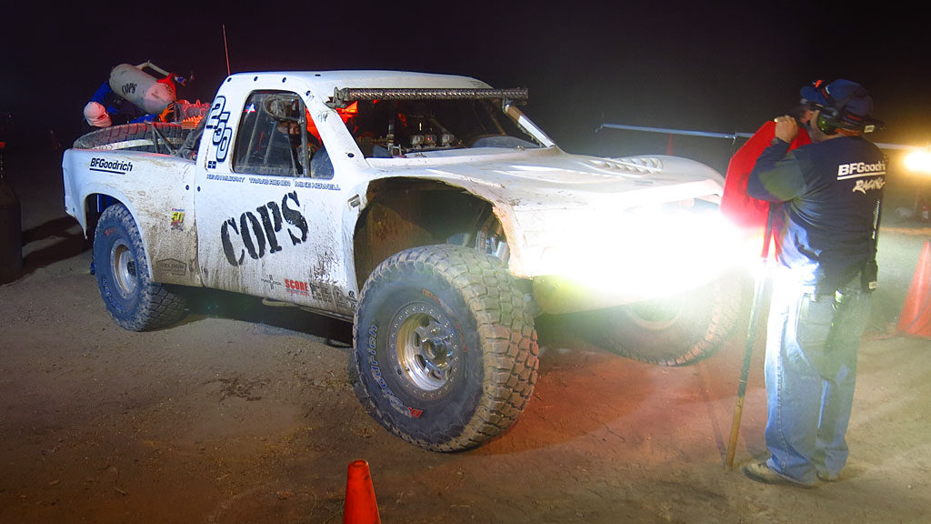 The COPS #250, making its inaugural run, takes on fuel at the BFG Pits at Race Mile 750. Steve Hengeveld is a full 20 minutes in front of the #2 guy in class. Kash Vessels drove the first third of the race before handing the truck over to Steve. Once he arrives in Loreto, Steve will hand over the driving duties to John who takes it to the finish. Time to pull that damaged front right fender out of short-term memory.